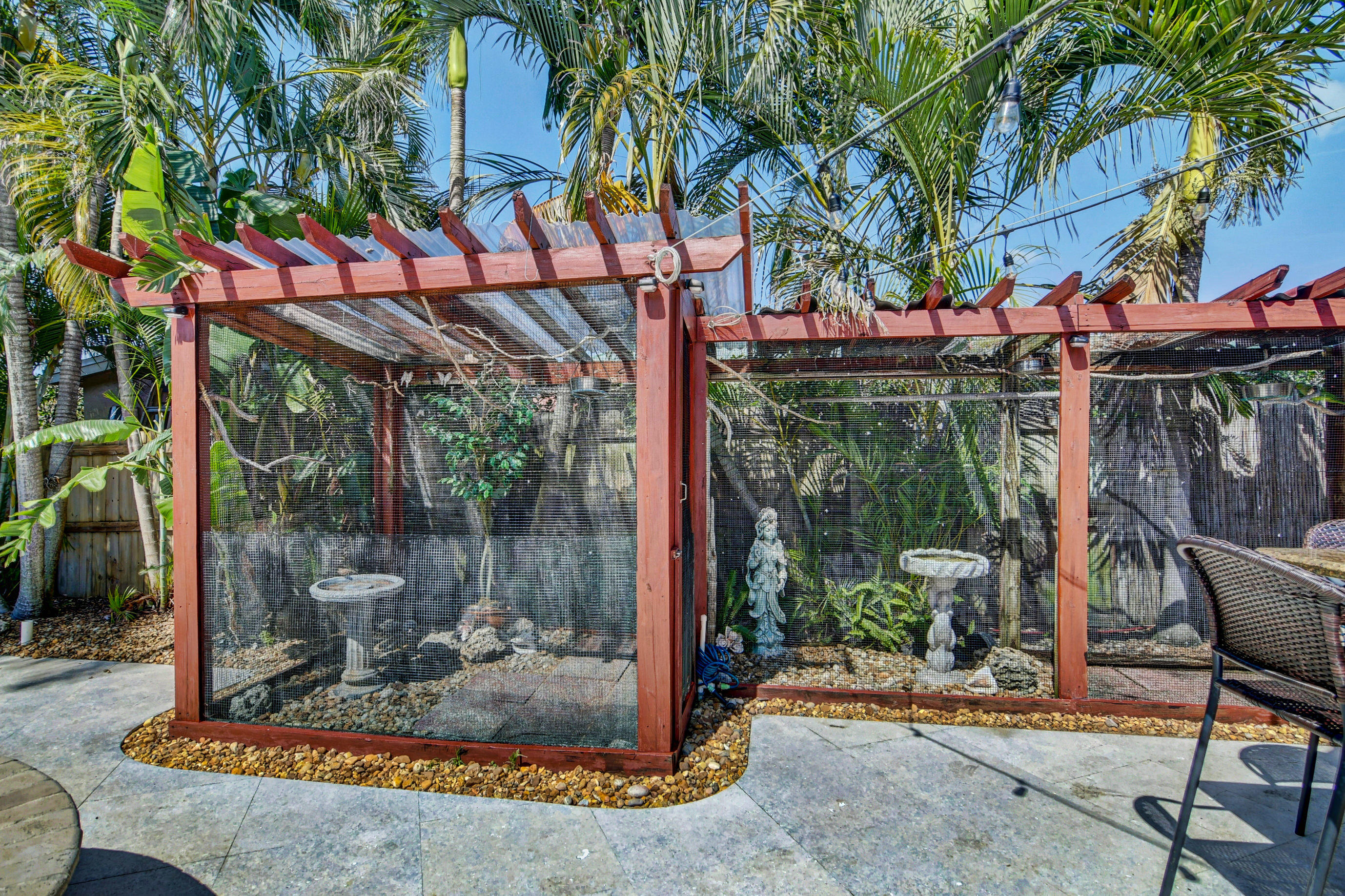 1720 Southwest 9th Street Boca Raton, FL 33486 - Photo 56 of 75 a view of a patio with a table and chairs under an umbrella
