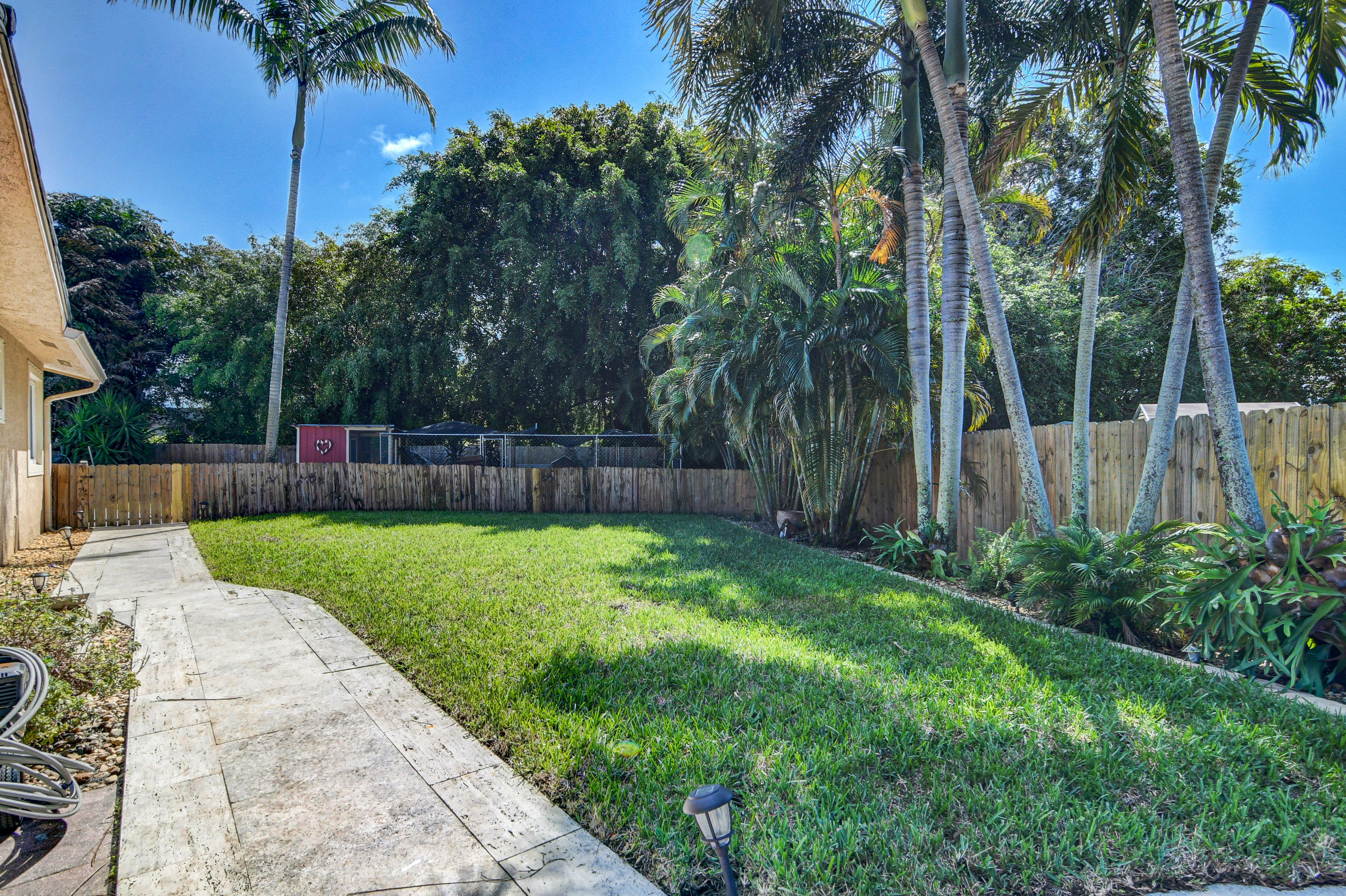 1720 Southwest 9th Street Boca Raton, FL 33486 - Photo 6 of 75 a view of a backyard with a garden and palm trees