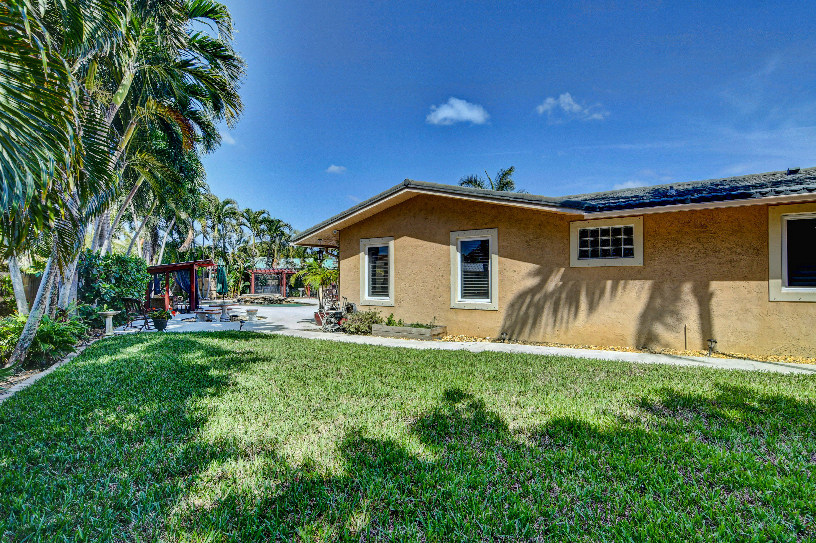 1720 Southwest 9th Street Boca Raton, FL 33486 - Photo 68 of 75 a view of a house with backyard and sitting area