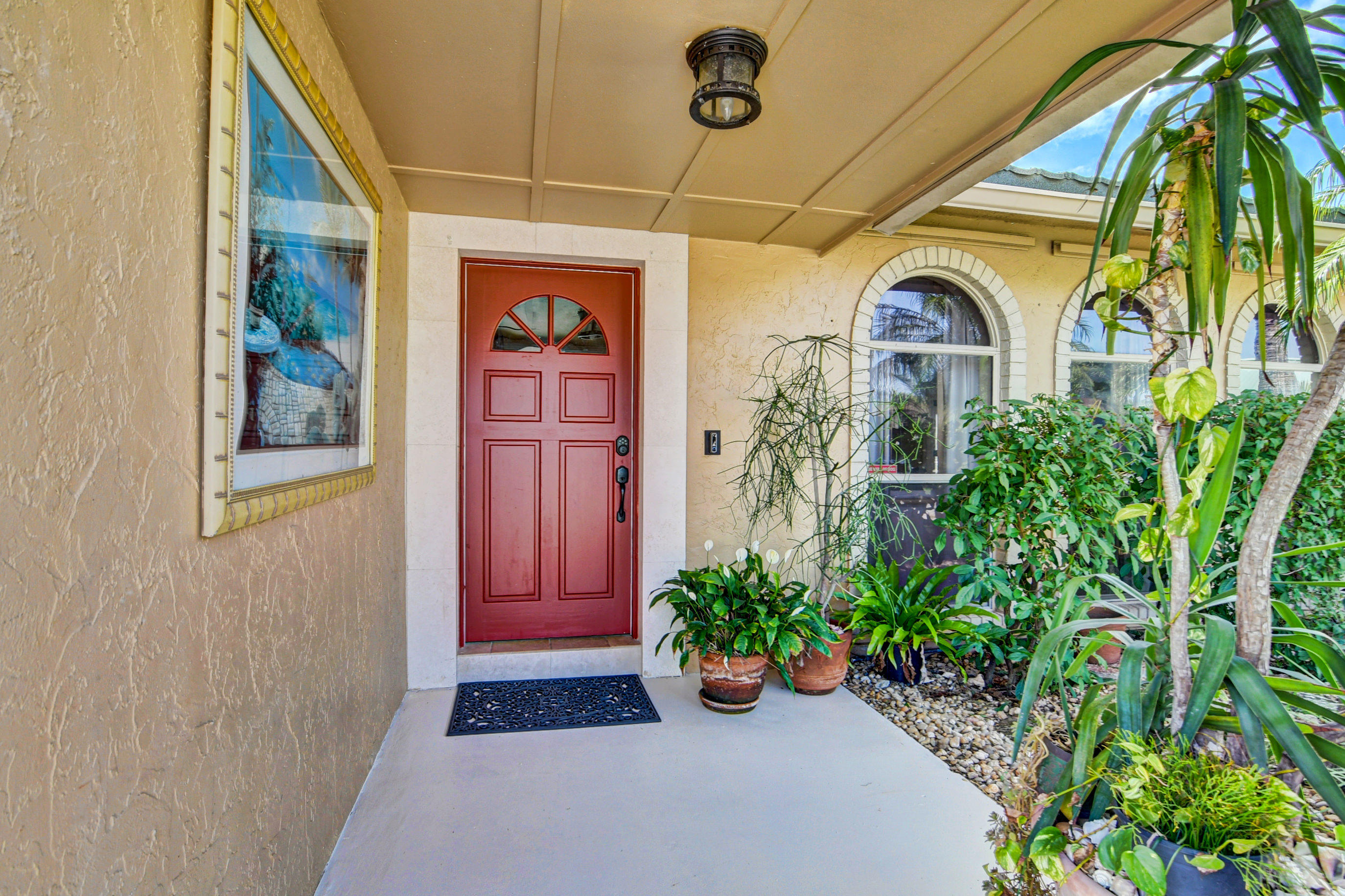 1720 Southwest 9th Street Boca Raton, FL 33486 - Photo 7 of 75 a front view of a house with a porch