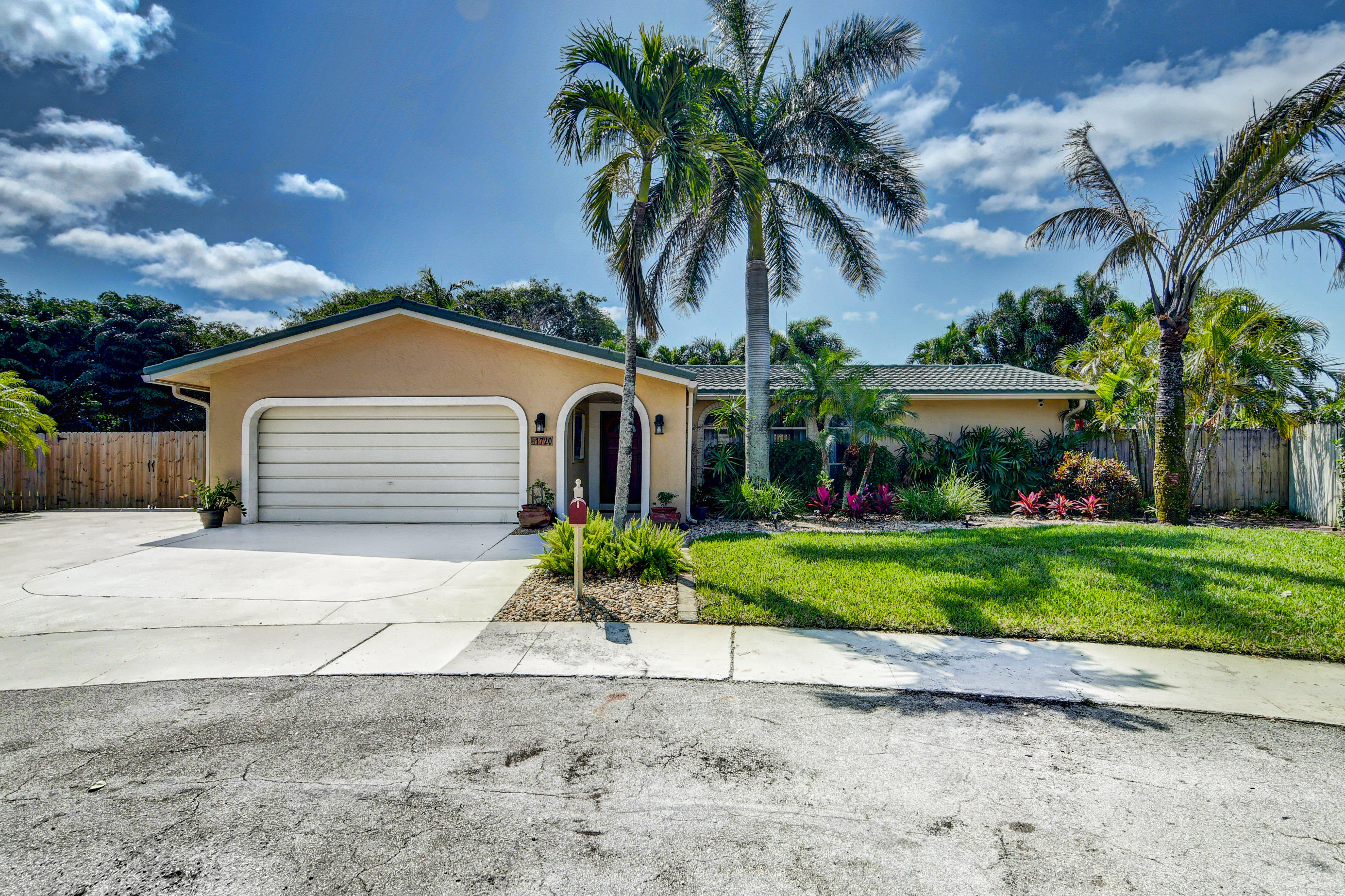 1720 Southwest 9th Street Boca Raton, FL 33486 - Photo 75 of 75 a front view of a house with a yard and garage