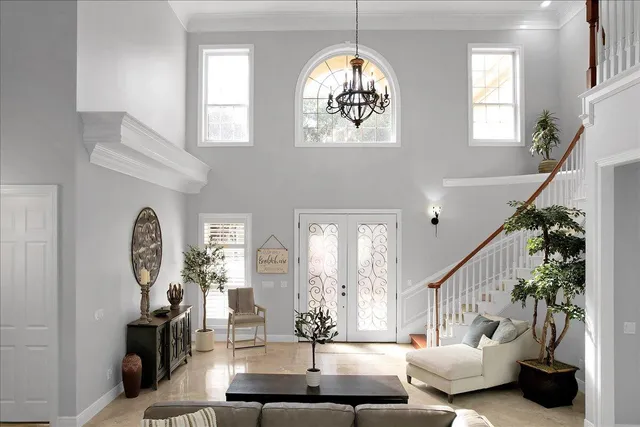 a living room with furniture and a chandelier
