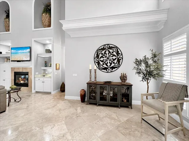 a living room with furniture a fireplace and a window