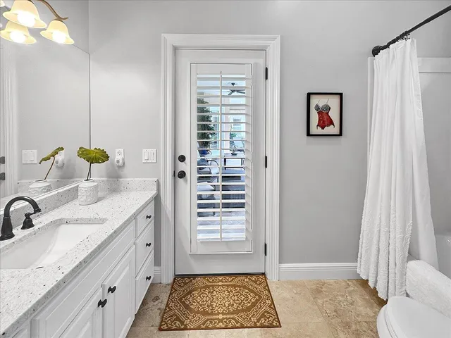 a bathroom with a glass shower door and a sink
