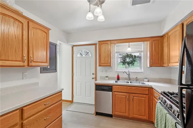 a kitchen with granite countertop a sink stainless steel appliances cabinets and a counter top space