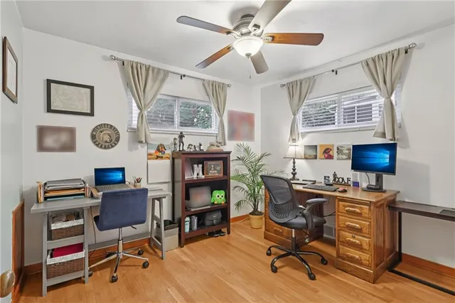 a view of a workspace with furniture and a window
