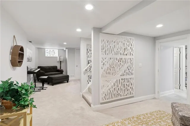 a living room with furniture and a painting on the wall