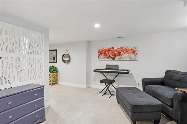 a living room with furniture and a potted plant