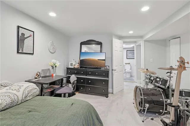 a bedroom with furniture a bed and a flat screen tv