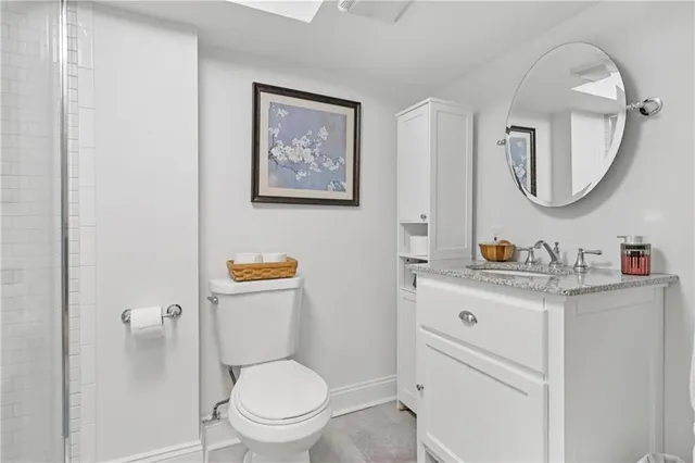 a bathroom with a toilet a sink and a mirror