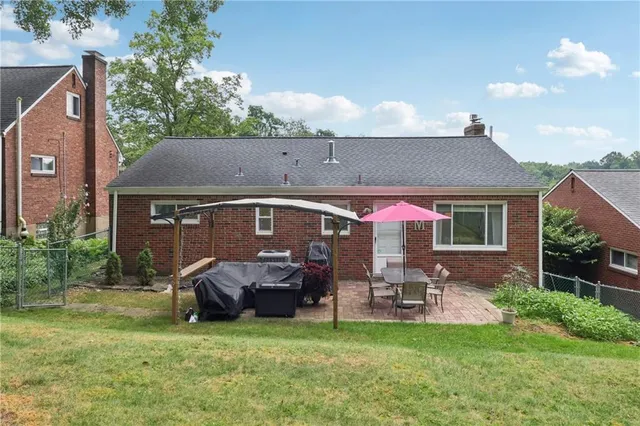 a front view of house with yard and outdoor seating