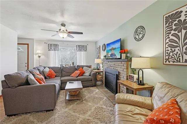 a living room with furniture and a fireplace