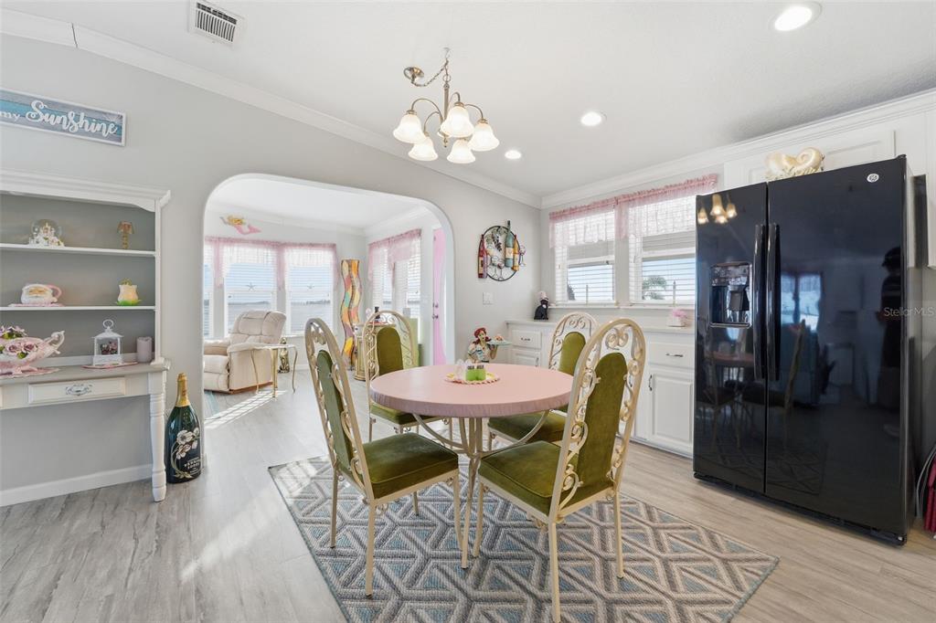10315 Cortez Road West, Unit 34BV Bradenton, FL 34210 - Photo 13 of 35 a view of a dining room with furniture window and wooden floor