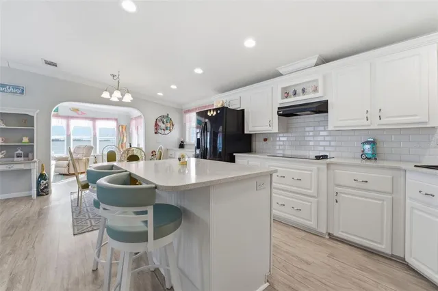 a kitchen with stainless steel appliances kitchen island granite countertop a sink and cabinets