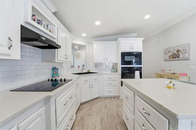 a kitchen with stainless steel appliances a sink stove and cabinets