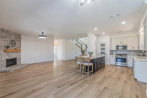 a view of a kitchen with furniture and wooden floor
