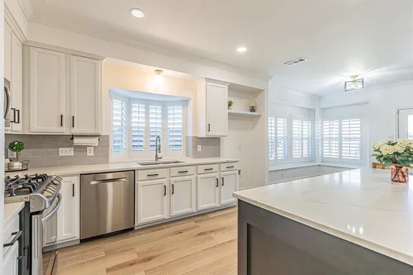 a kitchen with a sink stove and cabinets