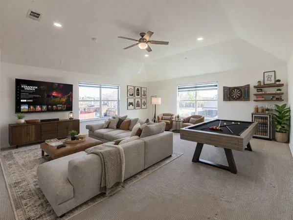 a view of a livingroom with a ceiling fan and window