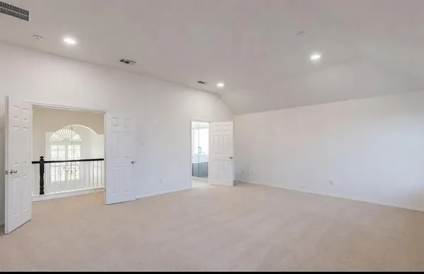 an empty room with fireplace and windows