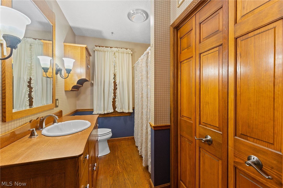 1815 Wick Campbell Road Hubbard, OH 44425 - Photo 20 of 43 Bathroom featuring oversized vanity, toilet, and hardwood / wood-style flooring
