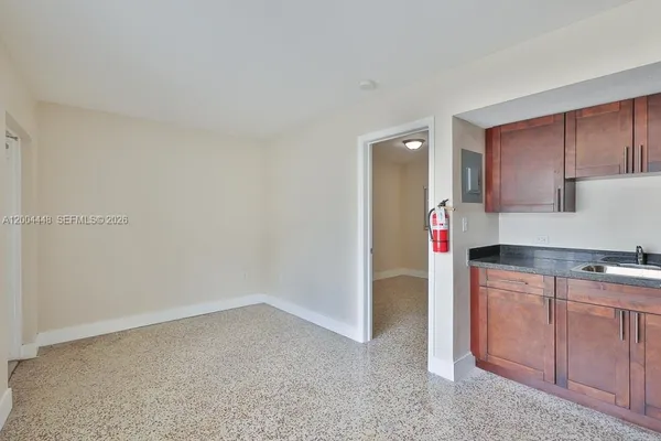 a kitchen with granite countertop a sink and a stove