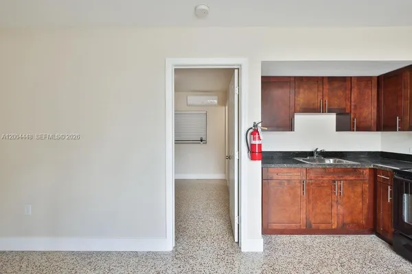 a kitchen with granite countertop a refrigerator and a stove