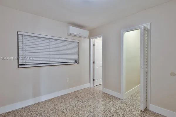 a view of an empty room with closet