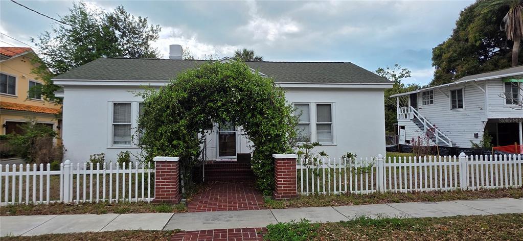 39 Turner Street Clearwater, FL 33756 - Photo 1 of 22 a view of a house with a small yard and wooden fence
