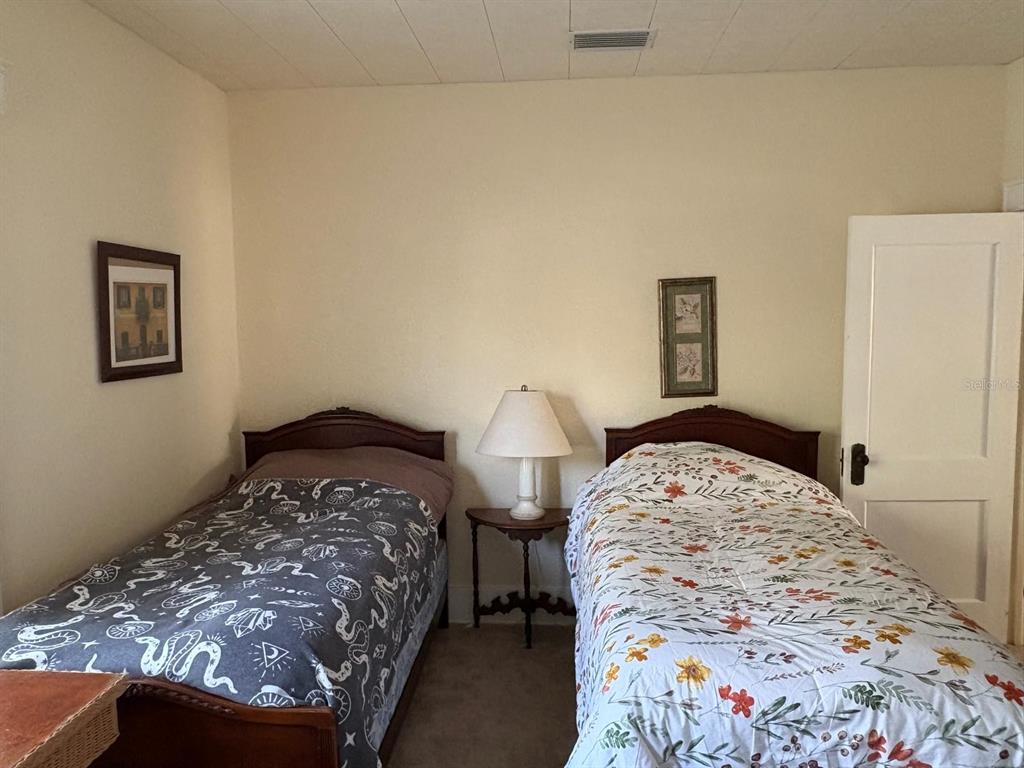 39 Turner Street Clearwater, FL 33756 - Photo 13 of 22 a bedroom with a bed and a lamp