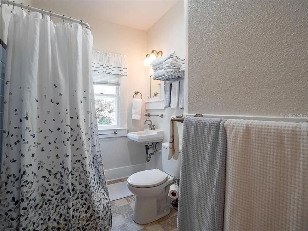 39 Turner Street Clearwater, FL 33756 - Photo 19 of 22 a bathroom with a toilet and a shower curtain