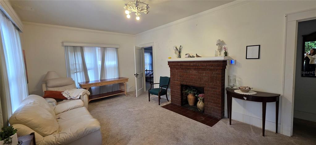 39 Turner Street Clearwater, FL 33756 - Photo 3 of 22 a living room with furniture and a fireplace
