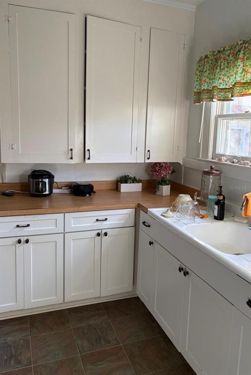 39 Turner Street Clearwater, FL 33756 - Photo 5 of 22 a kitchen with stainless steel appliances granite countertop a sink a stove and white cabinets