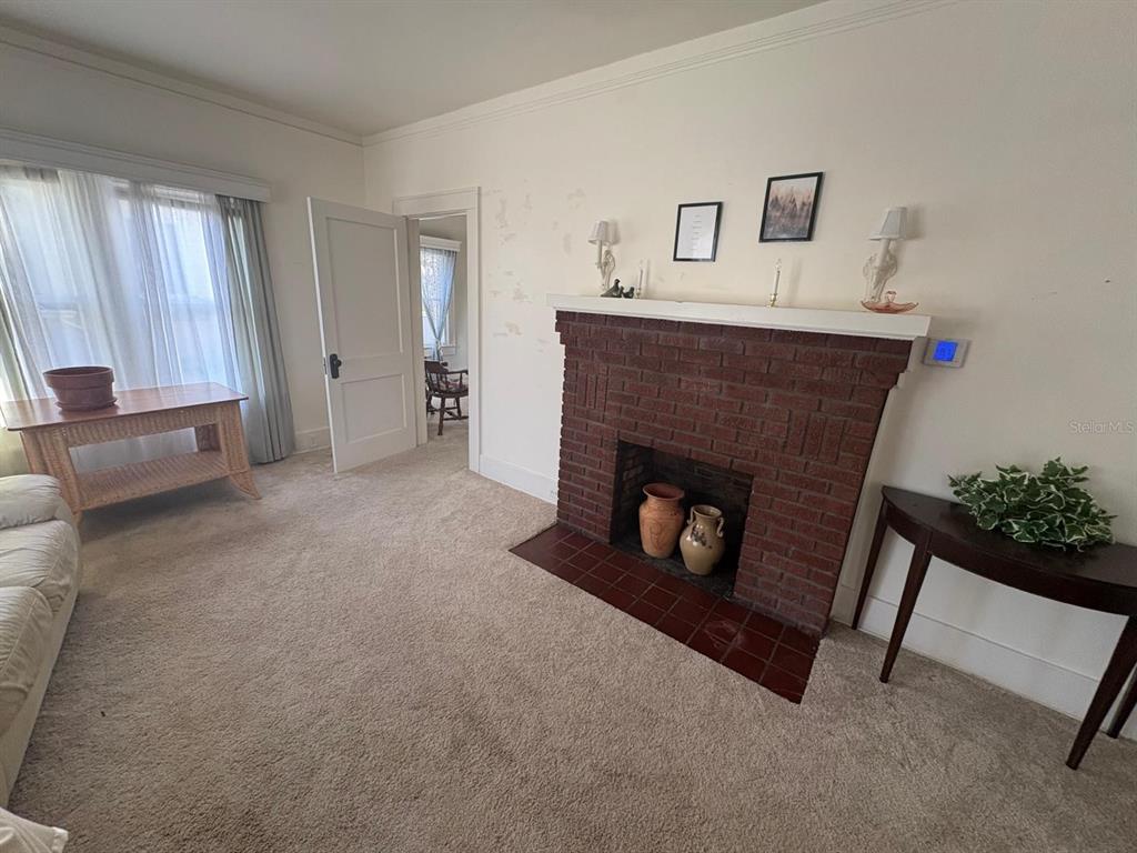 39 Turner Street Clearwater, FL 33756 - Photo 7 of 22 a living room with furniture and a fireplace