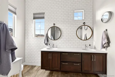 a bathroom with a double vanity sink and a mirror