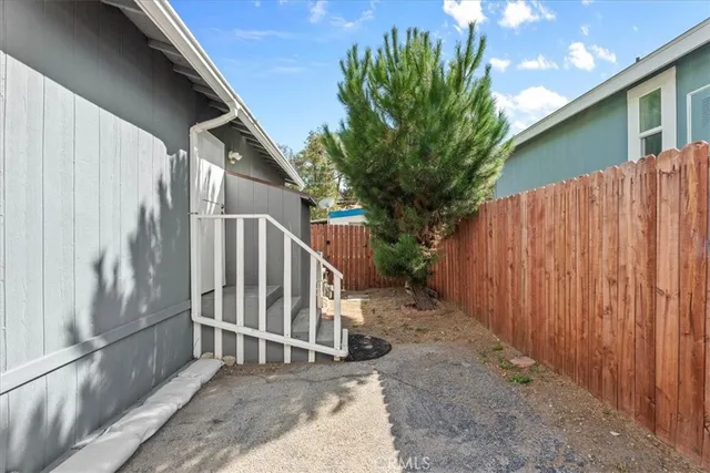 a view of entryway with wooden floor and fence