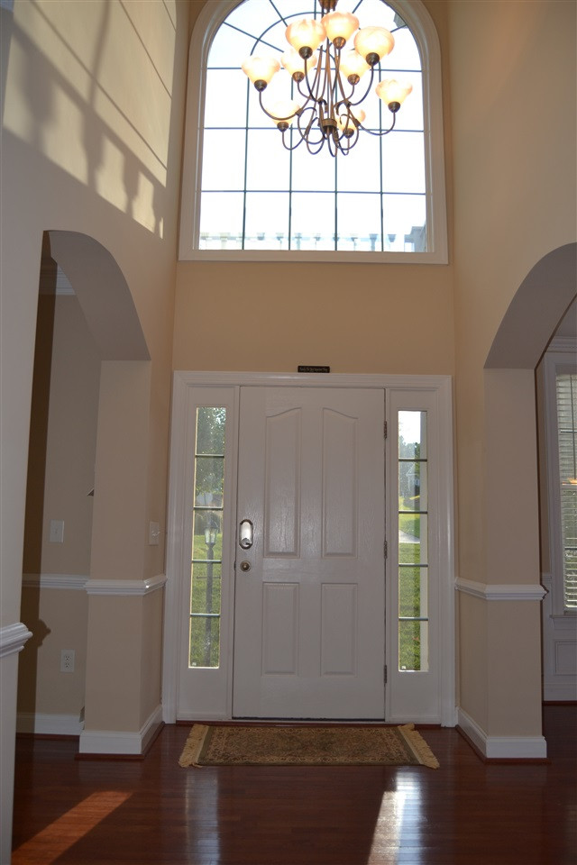 8425 Henderson Road Apex, NC 27539 - Photo 4 of 25 Evening sunlight shines into the arched window allowing for reflective lighting! Foyer