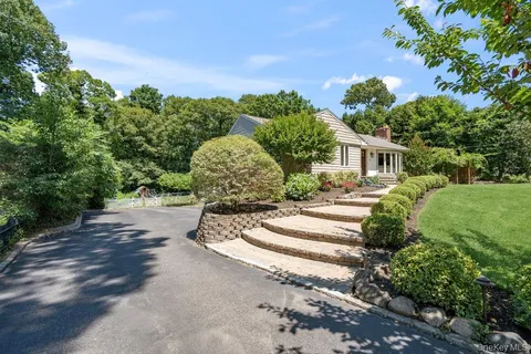 a view of a garden with a house in the background