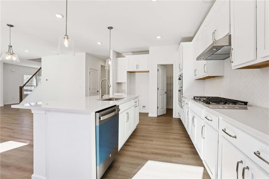 6155 Kismet Road Buford, GA 30518 - Photo 11 of 47 a large kitchen with stainless steel appliances lots of counter space a sink and a refrigerator