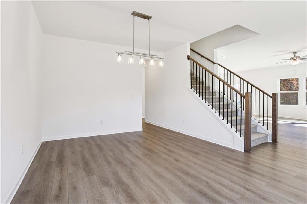 6155 Kismet Road Buford, GA 30518 - Photo 16 of 47 a view of a hallway with wooden floor and staircase