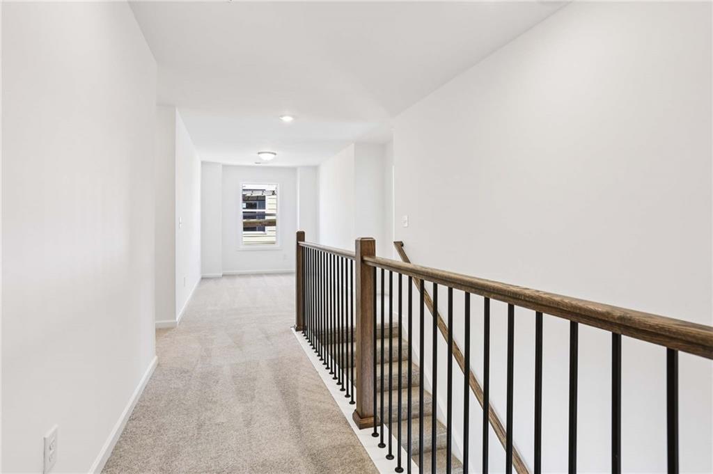 6155 Kismet Road Buford, GA 30518 - Photo 21 of 47 a view of a hallway with wooden floor and windows