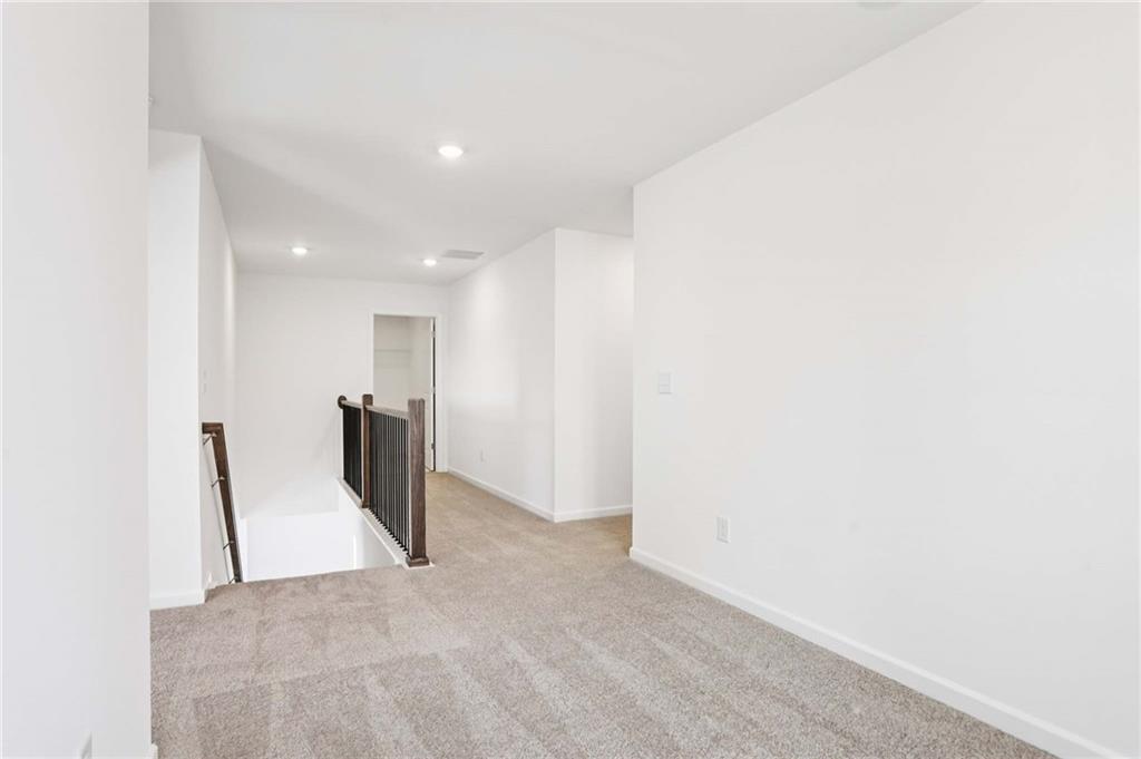 6155 Kismet Road Buford, GA 30518 - Photo 22 of 47 a view of a hallway with wooden floor