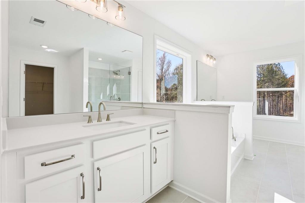 6155 Kismet Road Buford, GA 30518 - Photo 24 of 47 a bathroom with a sink and a mirror