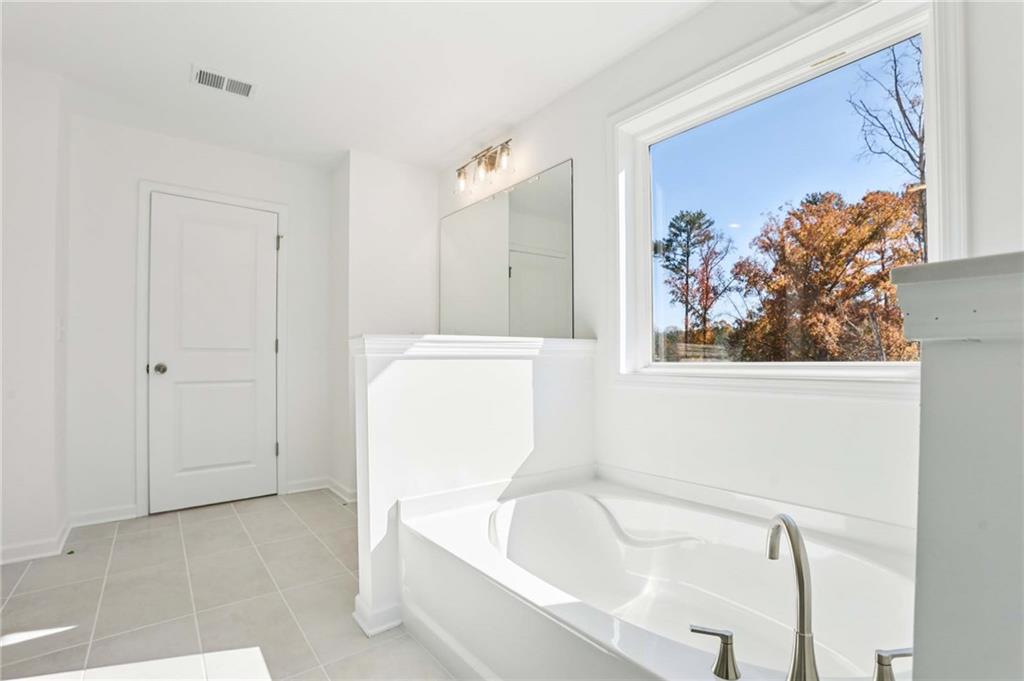6155 Kismet Road Buford, GA 30518 - Photo 25 of 47 a bathroom with a tub and shower