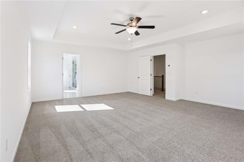 6155 Kismet Road Buford, GA 30518 - Photo 30 of 47 a view of an empty room with a ceiling fan