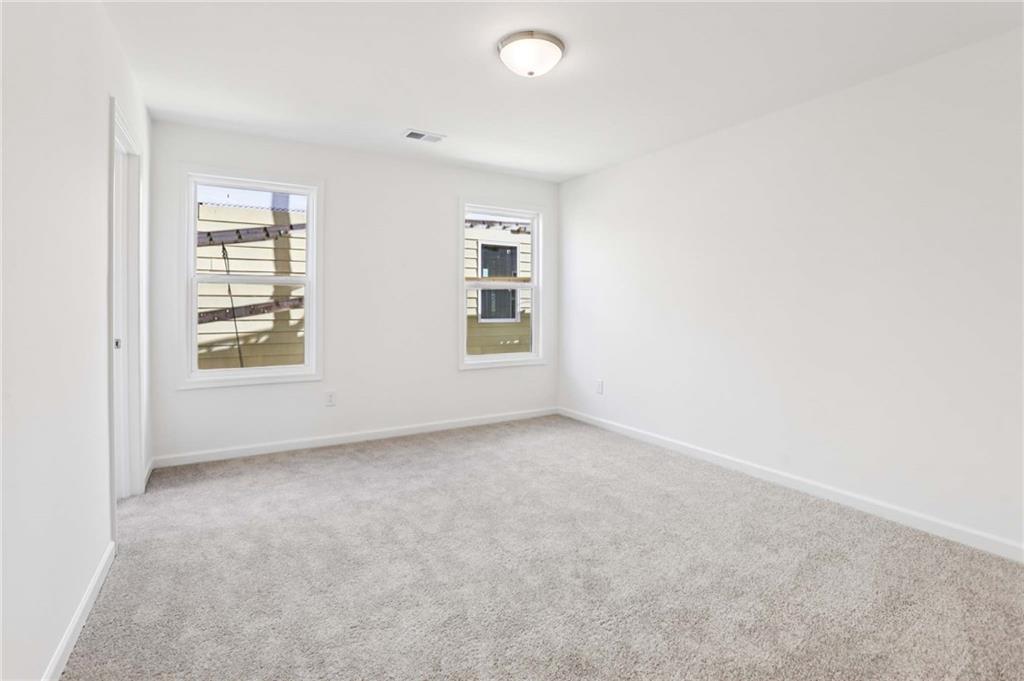 6155 Kismet Road Buford, GA 30518 - Photo 39 of 47 an empty room with windows