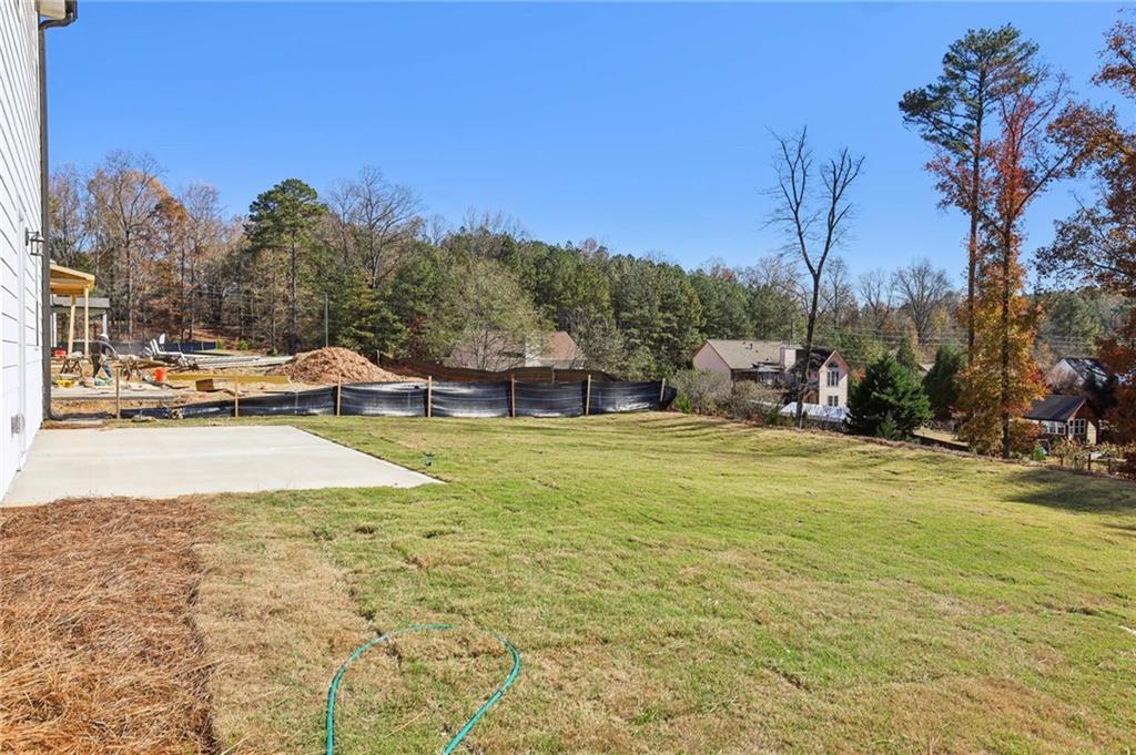 6155 Kismet Road Buford, GA 30518 - Photo 47 of 47 a view of a swimming pool with a house in the background