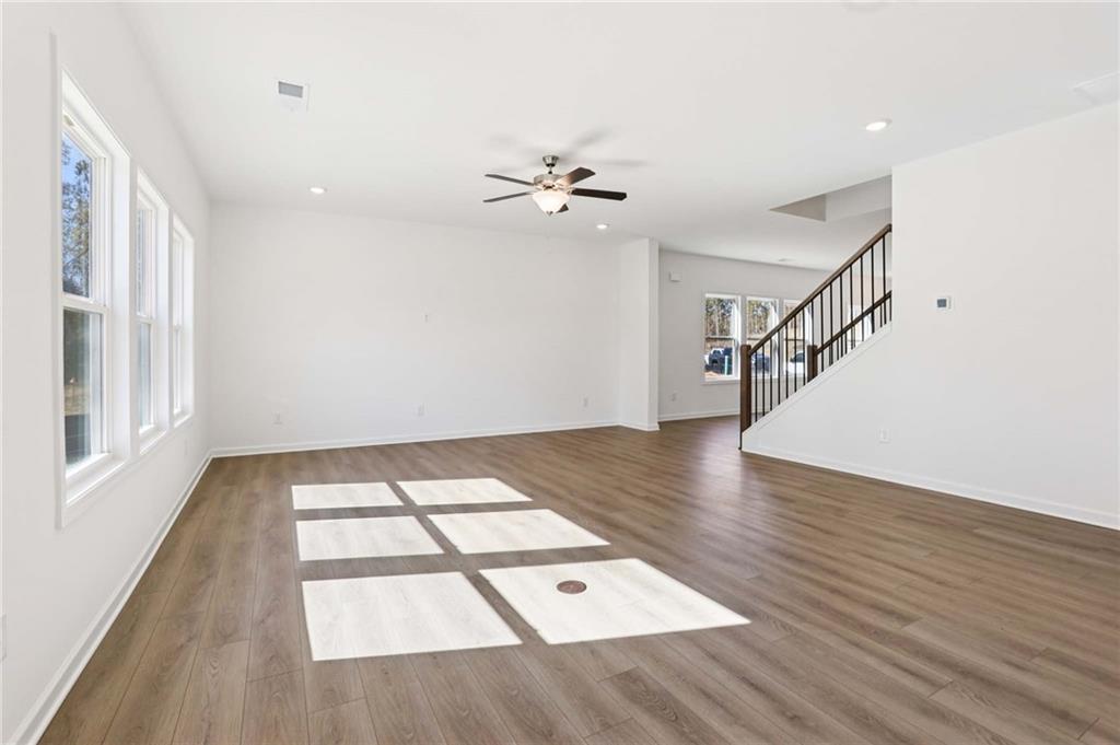6155 Kismet Road Buford, GA 30518 - Photo 5 of 47 wooden floor in an empty room with a window