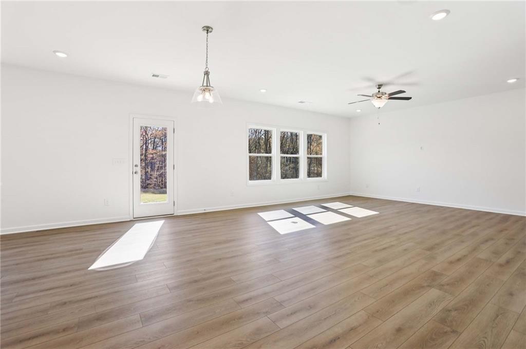 6155 Kismet Road Buford, GA 30518 - Photo 7 of 47 an empty room with wooden floor and windows