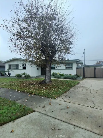 a front view of a house with a yard and a garage