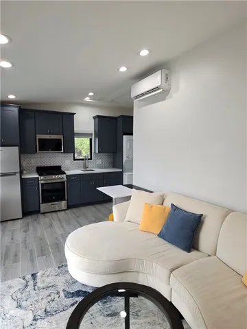a living room with furniture and kitchen view